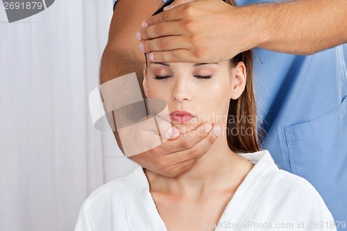 Image of Masseuse Giving Head Massage To Woman