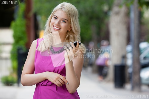Image of Woman Talking on Mobile Phone in City