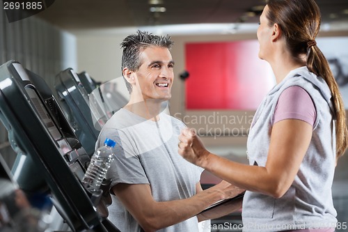 Image of Instructor With Female Client In Health Center