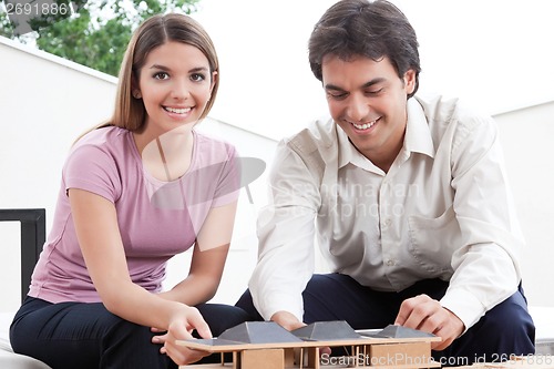 Image of Two Architects Building a House Model