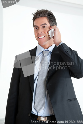 Image of Businessman On Call At Workplace