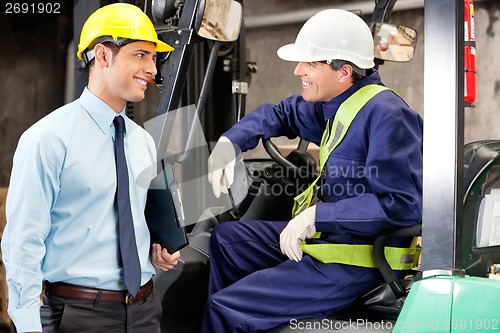 Image of Forklift Driver Communicating With Supervisor