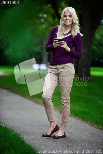 Image of Woman in Park with Cell Phone