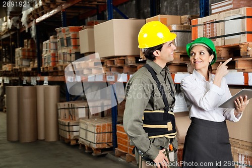 Image of Supervisor With Foreman Pointing At Stock On Shelves