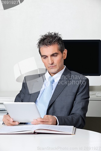 Image of Businessman Using Digital Tablet At Desk