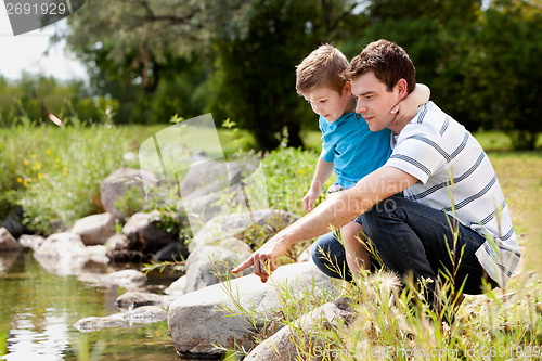 Image of Fashing and Son Playing Near Lake