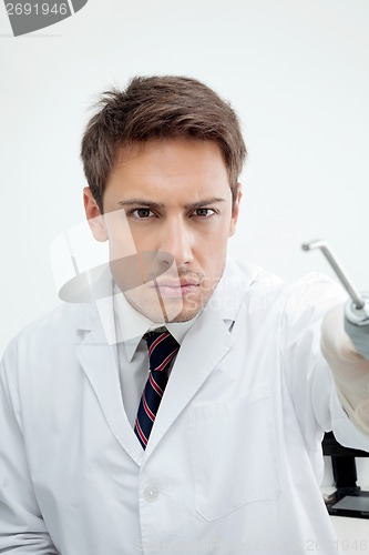 Image of Dentist Holding Water Spraying Tool