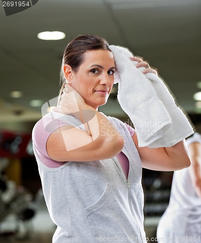 Image of Woman Wiping Sweat With Towel At Health Club