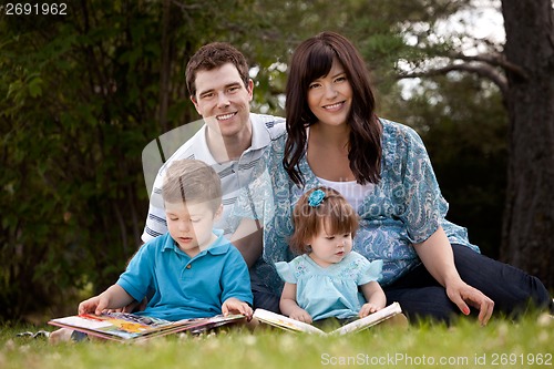 Image of Family Reading in Park