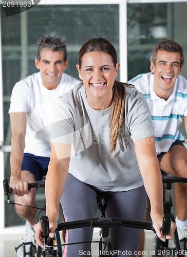 Image of Men And Woman On Exercise Bikes