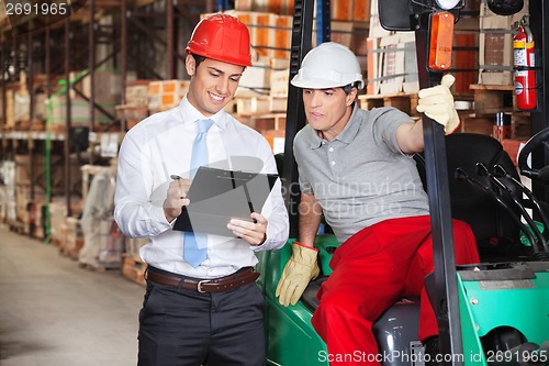 Image of Supervisor Showing Clipboard To Foreman