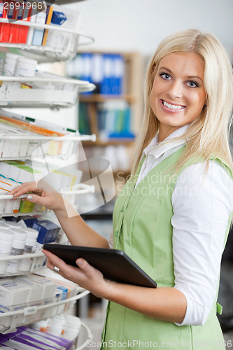 Image of Young Blond Pharmacist Using Digital Tablet