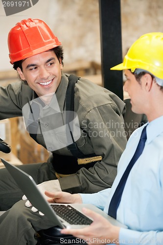 Image of Supervisor and Forklift Driver With Laptop