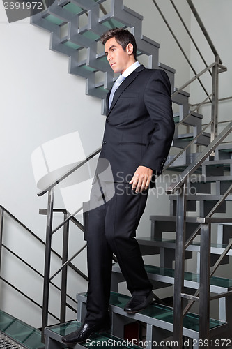 Image of Businessman Walking Down The Stairs