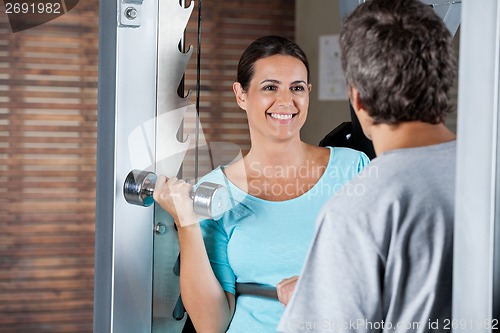 Image of Woman Lifting Weights While Looking At Instructor