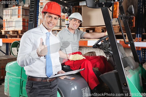 Image of Supervisor Gesturing Thumbs Up At Warehouse