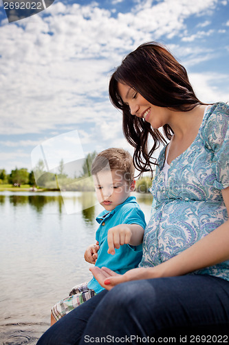 Image of Mother and Son Playing near Pond