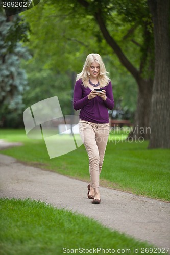 Image of Woman Using Smart Phone In Park