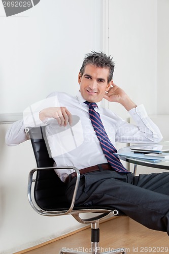 Image of Businessman Relaxing In Office