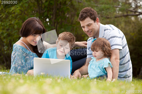 Image of Family Outdoors with Computer