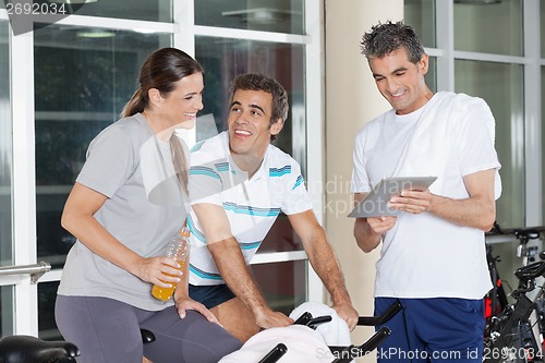 Image of Friends Using Digital Tablet In Gym