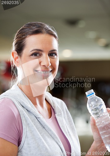 Image of Woman Holding Bottle Of Water At Health Club