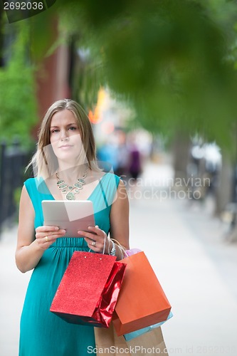 Image of Woman With Shopping Bags And Digital Tablet