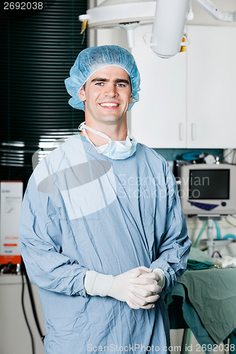 Image of Cheerful Male Surgeon With Hands Clasped