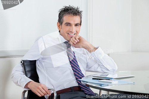 Image of Happy Businessman Relaxing In Office