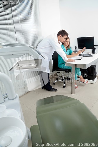 Image of Dentist And Assistant In Discussion