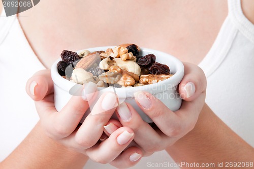 Image of Woman Holding Bowl of Dry Fruits