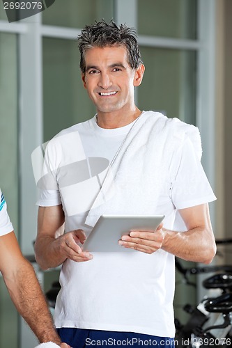 Image of Man Using Digital Tablet In Health Club