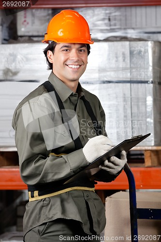 Image of Happy Male Supervisor Writing On Clipboard