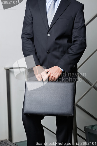 Image of Midsection Of Young Businessman Carrying Briefcase