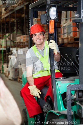 Image of Foreman Sitting In Forklift At Warehouse