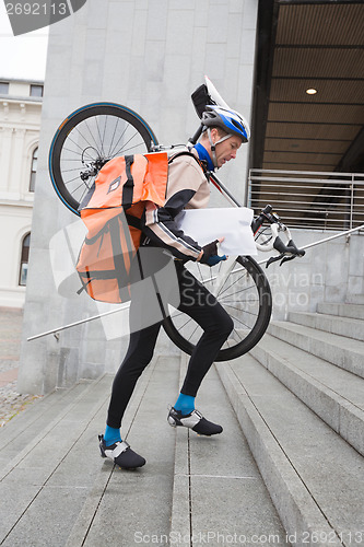 Image of Courier Delivery Man With Bicycle And Backpack Walking Up Stairs