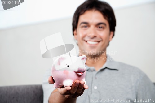 Image of Man Holding Piggy Bank