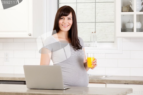 Image of Pregnant Woman with Laptop Computer