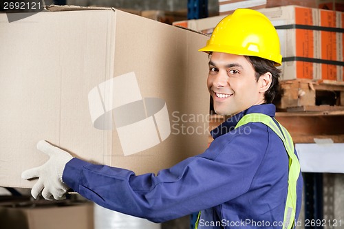 Image of Young Foreman Lifting Cardboard Box