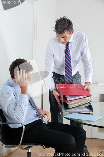 Image of Businessmen Overwhelmed By Load Of Work