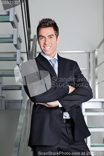 Image of Happy Businessman Standing On Stairs