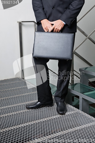 Image of Businessman With Briefcase Standing By Steps