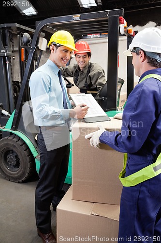 Image of Supervisor Showing Clipboard To Foreman