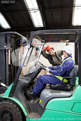 Image of Forklift Driver Communicating With Colleague