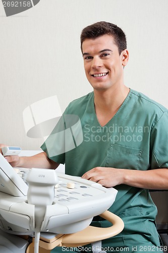 Image of Male Technician Operating Ultrasound Machine