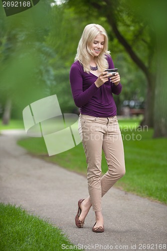 Image of Woman Using Smart Phone In Park