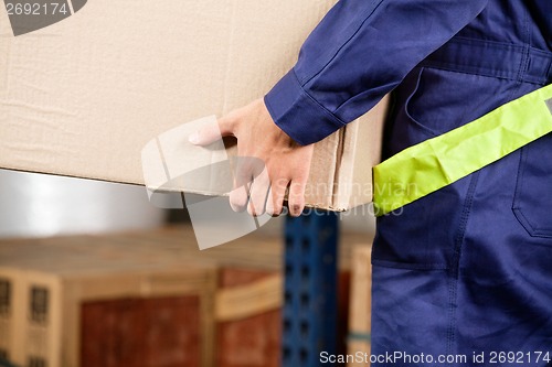 Image of Foreman Carrying Cardboard Box At Warehouse