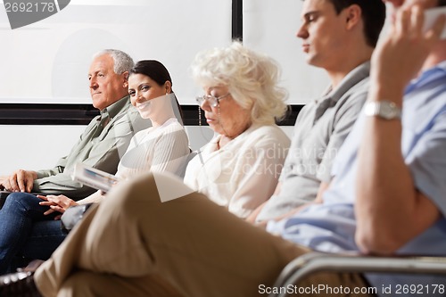 Image of Female Amidst Other People In Lobby