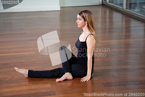 Image of Young Fit Woman Practicing Yoga