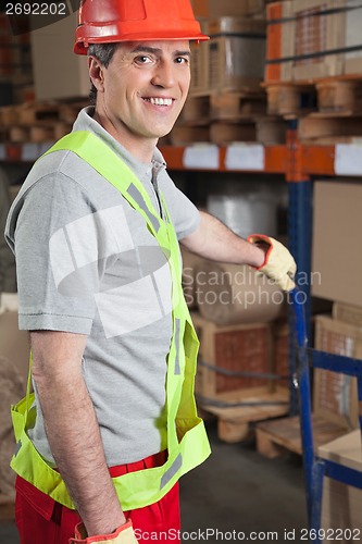 Image of Foreman Holding Handtruck At Warehouse